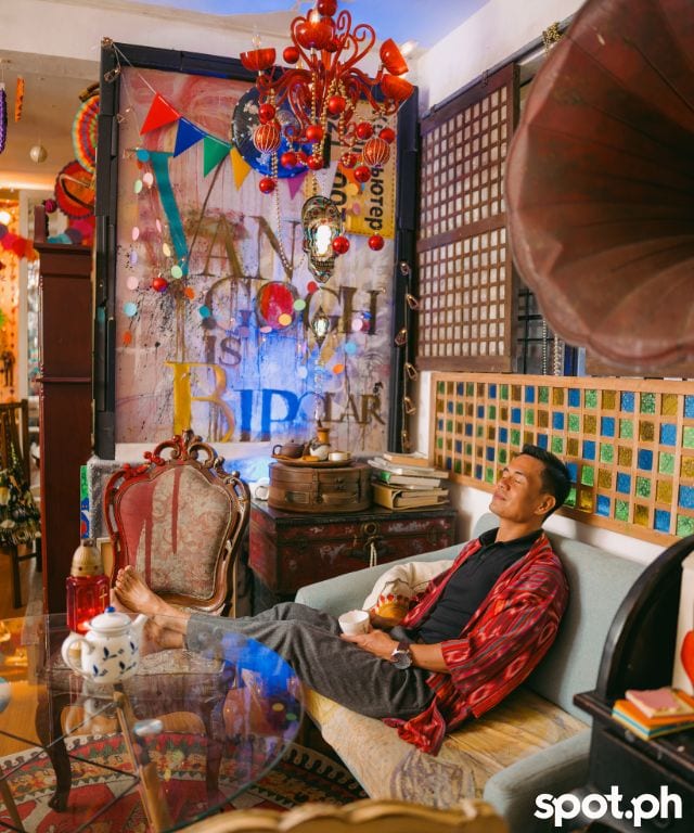 Jetro of Van Gogh is Bipolar rests by a mural by his life partner, Robert Alejandro.